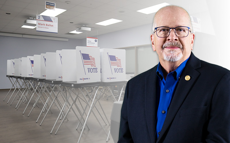 Craig Latimer in front of an image of a polling place